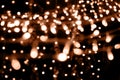 Blurry garland lights on a dark background. Festive Christmas and New Year background. Soft focus. Image toned in color