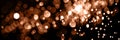 Blurry garland lights on a dark background. Festive Christmas and New Year background. Soft focus. Image toned in color