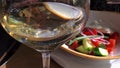 Blurry golden white wine in glass on defocused background Royalty Free Stock Photo