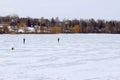 Blurry human`s silhouettes on frozen lake. Cropped shot of frozen lake. Abstract winter background.