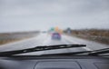 Blurry image of car windshield with rain drops driving in bad weather at highway Royalty Free Stock Photo