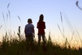 Blurry image of children playing outdoor over blue sky background. Family, childhood, friendship concept. Kids silhouettes. Royalty Free Stock Photo