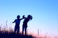 Blurry image of children playing outdoor over blue sky background. Family, childhood, friendship concept. Kids silhouettes. Royalty Free Stock Photo