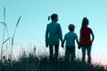 Blurry image of children standing in a clearing holding hands. People, children, childhood and family concept. Royalty Free Stock Photo