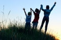 Blurry image of children standing in a clearing holding hands up. People, children, childhood and family concept. Royalty Free Stock Photo
