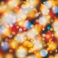 Blurry image containing bokeh effect with multicolored circles in shades of orange, red Royalty Free Stock Photo