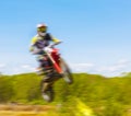 The blurry image of motorcycle rider during motocross race