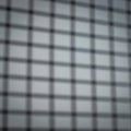 Blurry image showing a grid pattern. The grid consists of horizontal and vertical lines Royalty Free Stock Photo