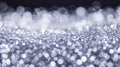A blurry image of a silver object with many small circles surrounding it