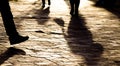 Blurry legs silhouettes and shadows of people walking in sunset Royalty Free Stock Photo