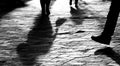 Blurry legs silhouettes and shadows of people walking in sunset Royalty Free Stock Photo