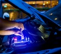 Blurry of male mechanic changing car battery, mechanic engineer fixing car battery