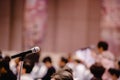 Blurry of microphone in auditorium and projector for shareholders ` meeting Royalty Free Stock Photo