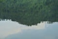 Blurry mountain reflection on water surface in lake Royalty Free Stock Photo