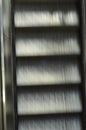 Blurry moving metallic escalator in a shopping mall, airport, metro, train station or other building. Perspective, going up or Royalty Free Stock Photo