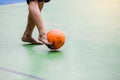 Blurry orange ball after futsal player shoot it to goal. Indoor soccer sports hall Royalty Free Stock Photo