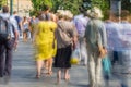 Blurry people walking in the street