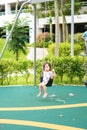 Blurry photo of an active little toddler child playing swing at the playground. Happy and fun time Royalty Free Stock Photo