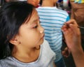 Blurry photo of Children face painting. Artist painting little girl at the shop