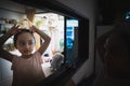 Blurry photo of a cute little girl mirror reflections in the living room