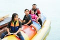 Blurry photo of family enjoying water activities on banana boat at the Kenyir Lake, Terengganu, Malaysia Royalty Free Stock Photo