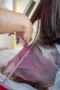 Blurry photo of hand doing hair cut. Close up