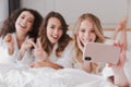 Blurry photo of happy smiling women 20s wearing white bathrobe l