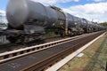 Blurry photo of railroad tank cars in motion, on a metal bridge over the river. Royalty Free Stock Photo