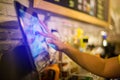 Blurry picture of cashier is making order on touch screen of computer in cafe or store