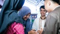 Blurry portrait close up shot of Muslim couples visiting their family or friend home while shaking hand and hugs on eid mubarak