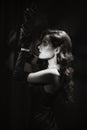 Portrait of a woman in the classic retro style of black and white Hollywood movies. Girl in a vintage look with makeup Royalty Free Stock Photo