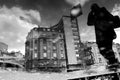 Blurry silhouette of a person reflecting in a puddle after the rain, BW Royalty Free Stock Photo