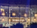 A blurry reflection of a restaurant with lights hanging from the ceiling Royalty Free Stock Photo