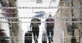 Blurry reflection silhouette on wet city street of two tourist people walking under umbrella in the rain