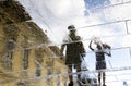 Blurry reflection silhouettes of father and child walking on a