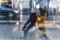 Blurry reflection silhouettes of the people in walking on a rain, night street scene, blurred motion. Concept of seasons Royalty Free Stock Photo