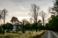 Blurry and scary landscape with buddhist temple, road and forest at sunset Royalty Free Stock Photo