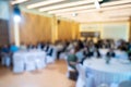 Blurry seminar hall with audience student in it. This room are arranged by round circle group table that appropriate for workshop Royalty Free Stock Photo