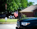 Blurry senior couple waving hands with modern pickup truck driving on residential street smalltown Fourth of July parade, Dallas, Royalty Free Stock Photo