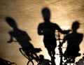 Blurry shadow of three young women on bikes