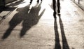 Blurry shadows and silhouettes on city sidewalk Royalty Free Stock Photo