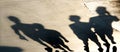 Blurry shadows silhouettes of young people walking on summer sunset Royalty Free Stock Photo