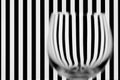 Blurry shape of the empty glass against stripes