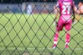 Blurry shot image of back of goal keeper in the football or soccer in the stadium.