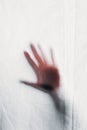 blurry silhouette of human hand touching veil