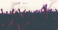 Blurry of silhouettes of concert crowd at Rear view of festival crowd raising their hands on bright stage lights Royalty Free Stock Photo