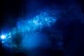 Blurry smoke abstract background blue color on black night . free form swirl flowing fog in the air