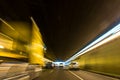 Blurry speeding car in a tunnel with light trails