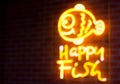 Blurry text fish neon light on wall