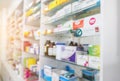 Blurry view of drug store and pharmacist. Blurred clean pharmacy with medicine on shelves. Defocus white drugstore